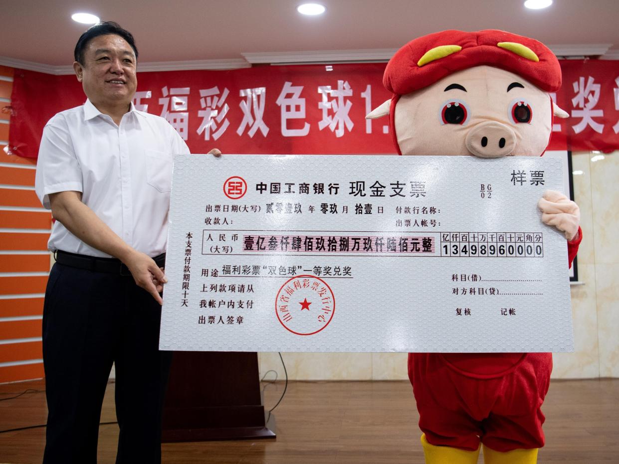 The winner of the nearly 135 million (about 21.2 million US dollars) lottery jackpot dressed as cartoon character 'GG Bond' claims prize on September 11, 2019 in Taiyuan, Shanxi Province of China.