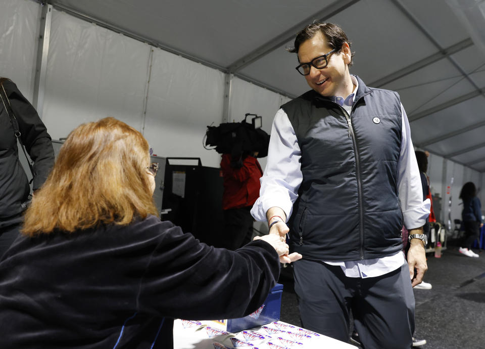 FILE - Nevada Secretary State Cisco Aguilar shakes hands with poll worker Esmeralda Reynold during primary voting Tuesday, Feb. 6, 2024, in Las Vegas. Even without Donald Trump on Nevada’s Republican ballot, Nikki Haley was still denied her first victory. The indignity of a distant second-place finish behind “none of these candidates” was a blow for Haley facilitated by the staunch Trump allies who lead Nevada’s GOP. They had already maneuvered to ensure Trump has a lock on the state’s 26 delegates, who will be awarded in caucuses on Thursday where he faces only token opposition. (Bizuayehu Tesfaye/Las Vegas Review-Journal via AP, File)