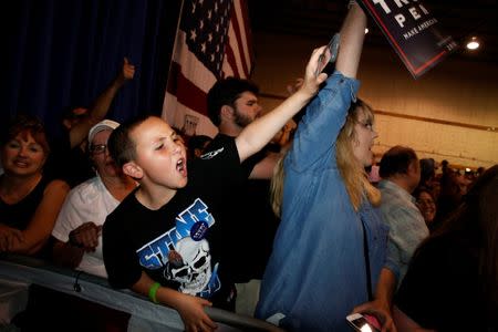 A boy cheers as Republican presidential nominee Donald Trump holds a rally with supporters in Aston, Pennsylvania, U.S. September 22, 2016. REUTERS/Jonathan Ernst