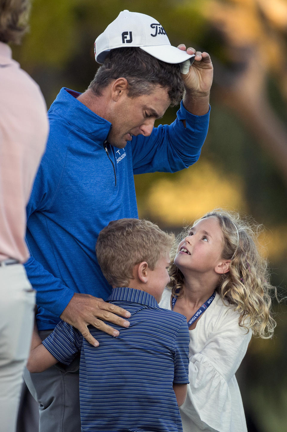 Charles Howell III looks at his children Charles and Ashley after winning a playoff against Patrick Rodgers following the final round of the RSM Classic golf tournament Sunday, Nov. 18, 2018, in St. Simons Island, Ga. (AP Photo/Stephen B. Morton)