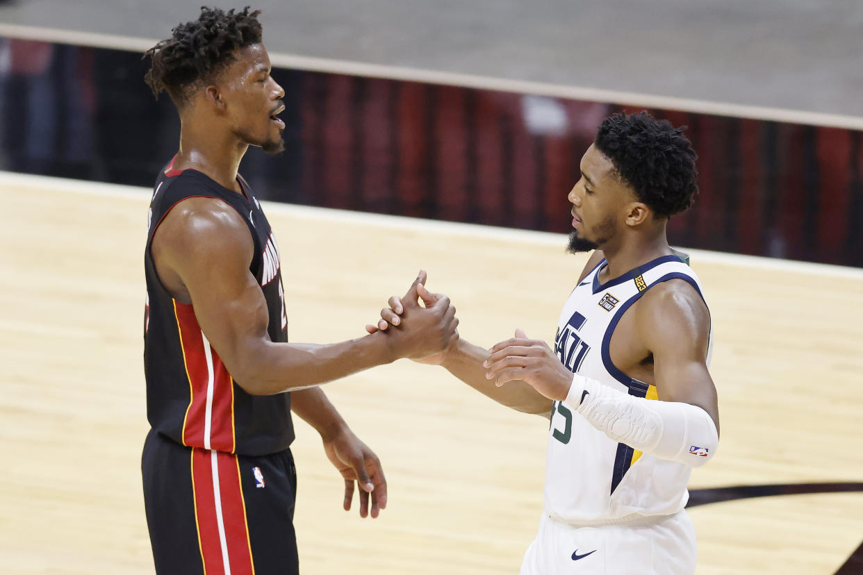 Jimmy Butler of the Miami Heat shakes hands with Donovan Mitchell of the Utah Jazz after the game at American Airlines Arena on February 26, 2021 in Miami, Florida.