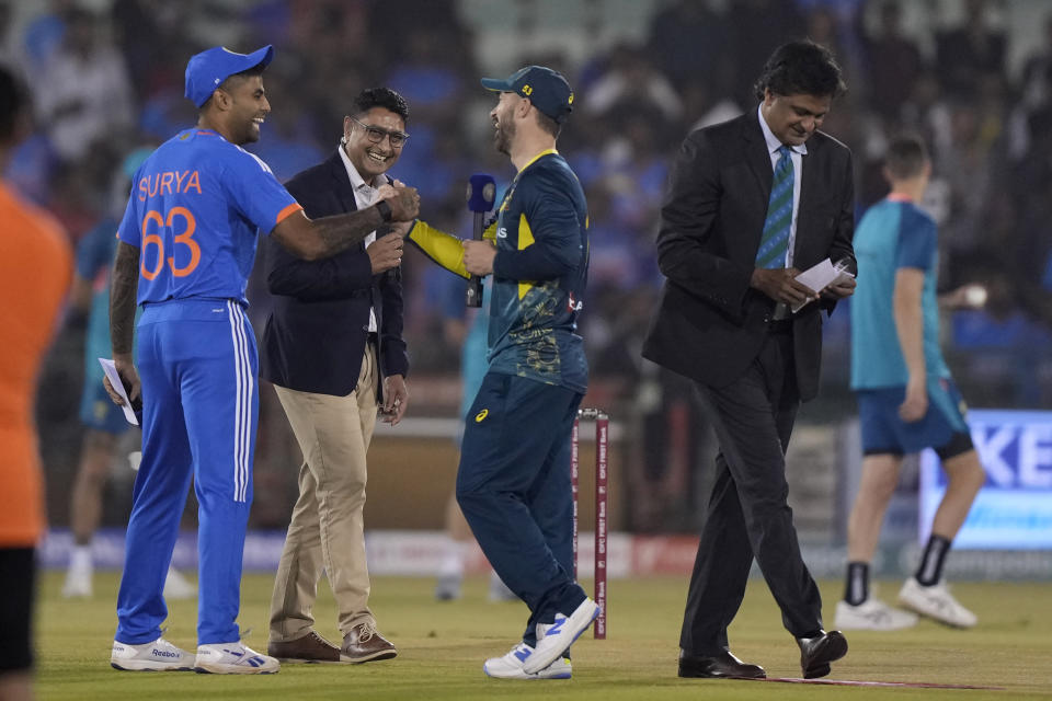 Australia's captain Matthew Wade and India's captain Suryakumar Yadav share a light moment before the start of the fourth T20 cricket match between Australia and India in Raipur, India, Friday, Dec. 1, 2023. (AP Photo/Mahesh Kumar A.)