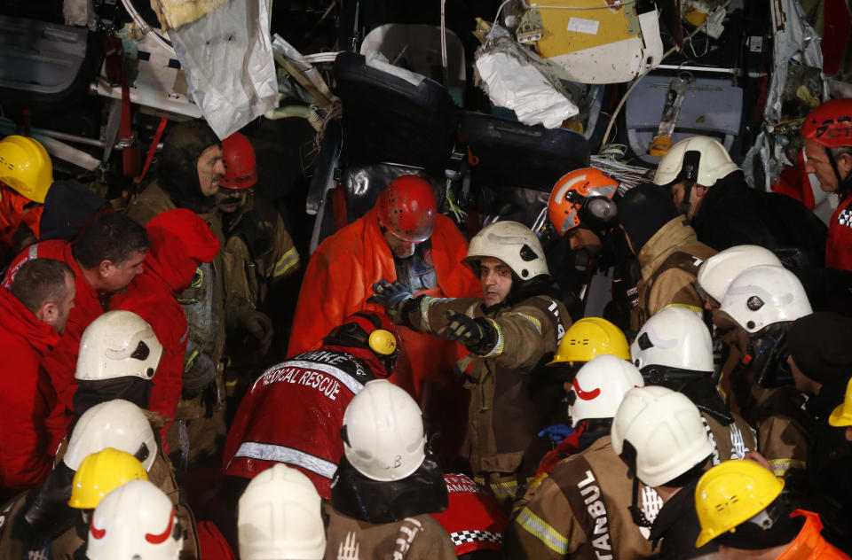 Rescue members evacuate an injured person from the wreckage of a plane after it skidded off the runway at Istanbul's Sabiha Gokcen Airport, in Istanbul, Wednesday, Feb. 5, 2020. The plane skidded off as it tried to land in bad weather, crashing into a field and breaking into pieces. Passengers had to evacuate through cracks in the smashed plane and authorities said 120 people were sent to the hospital with injuries. (AP Photo/Emrah Gurel)