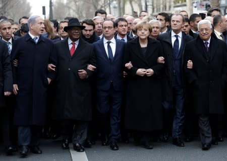 FILE PHOTO: French President Hollande is surrounded by head of states as they attend the solidarity march in the streets of Paris