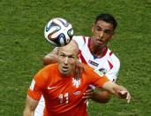 Arjen Robben of the Netherlands (front) looks at the ball as he is challenged by Costa Rica's Michael Umana during their 2014 World Cup quarter-finals at the Fonte Nova arena in Salvador July 5, 2014. REUTERS/Ruben Sprich