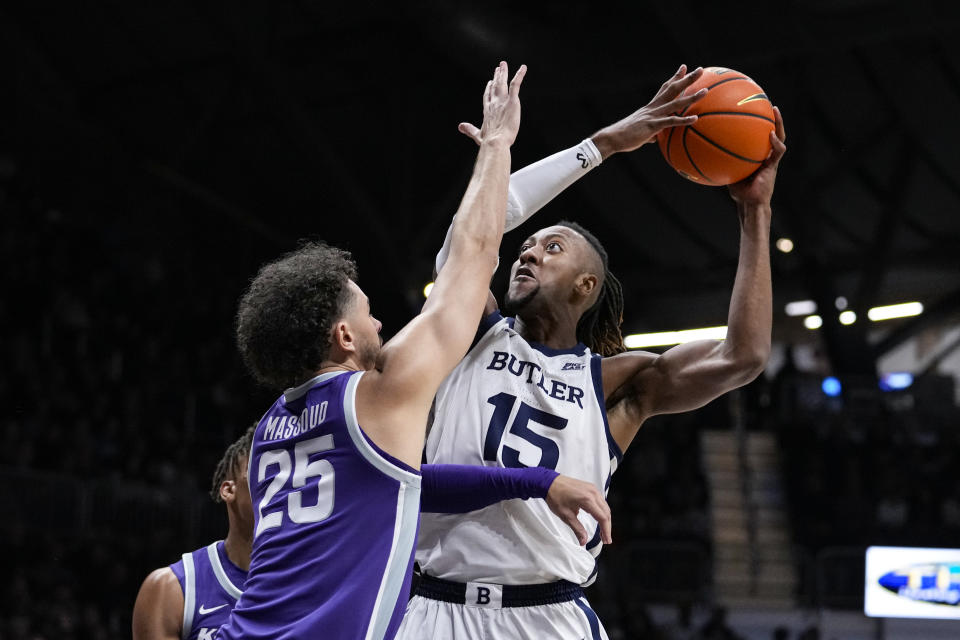 Butler center Manny Bates (15) shoots over Kansas State forward Ismael Massoud (25) in the first half of an NCAA college basketball game in Indianapolis, Wednesday, Nov. 30, 2022. (AP Photo/Michael Conroy)