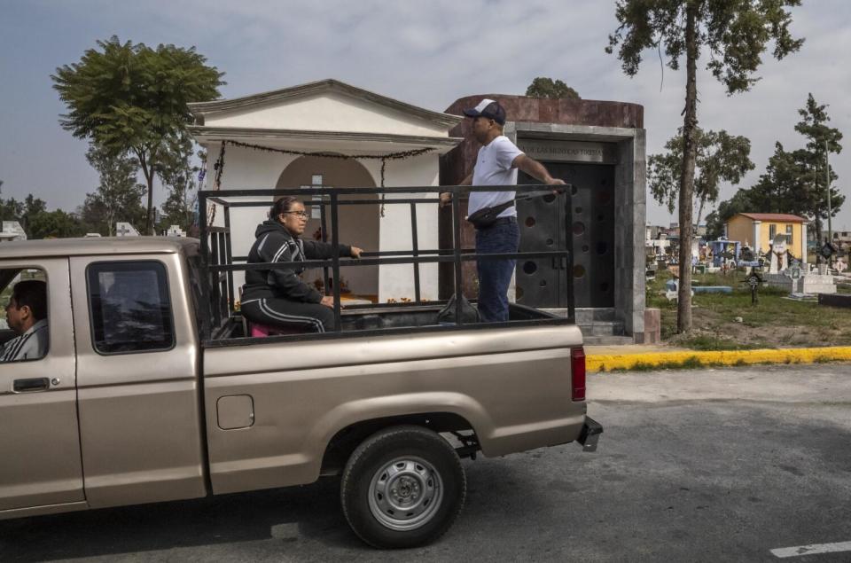 Two people in the bed of a pickup truck