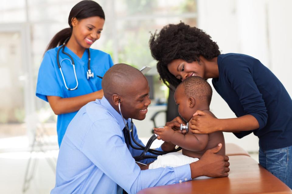 african mother and her son in doctor's office