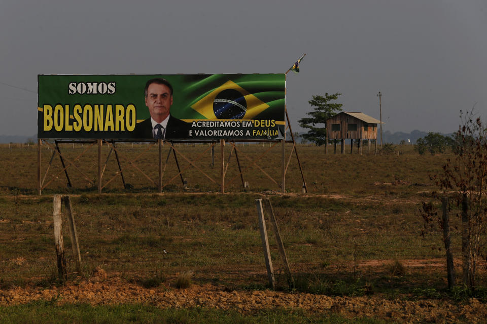 FILE - A billboard in support of the Brazilian President who is running for reelection, Jair Bolsonaro, with phrases written in Portuguese, left, "We are Bolsonaro," right, "We Believe in God and Value the Family," is displayed at the entrance of a farm in the municipality of Humaita, Amazonas state, Brazil, Sept. 17, 2022. Far-right President Jair Bolsonaro is seeking a second four-year term against leftist Luiz Inácio Lula da Silva, who ruled Brazil between 2003 and 2010 and leads the polls. (AP Photo/Edmar Barros, File)