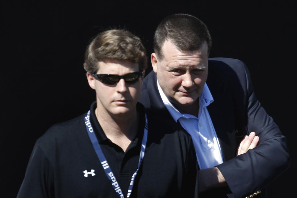 FILE - In this Feb. 19, 2008, file photo, New York Yankees senior vice president Hank Steinbrenner, right, talks to his brother Hal Steinbrenner while watching action in the bullpen during spring training baseball workouts in Tampa, Fla. Henry "Hank" Steinbrenner died Tuesday, April 14, 2020, at his home in Clearwater, Fla. He was 63.(AP Photo/Julie Jacobson, File)