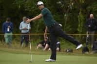 Adam Scott of Australia reacts after putting on the fourth green during a practice round ahead of the British Open Championship at the Royal Liverpool Golf Club in Hoylake, northern England July 16, 2014. REUTERS/Toby Melville (BRITAIN - Tags: SPORT GOLF)