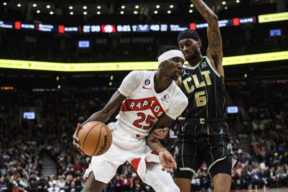 Toronto Raptors forward Chris Boucher (25) is defended by Charlotte Hornets forward Jalen McDaniels (6) during the first half of an NBA basketball game Tuesday, Jan. 10, 2023, in Toronto. (Christopher Katsarov/The Canadian Press via AP)