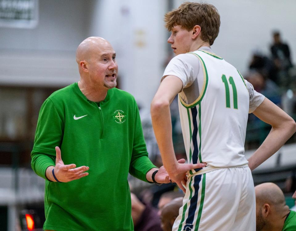 Indianapolis Cathedral High School head coach Jason Delaney talks with junior Brady Koehler (11) during a break in the first half of an Indianapolis Boys Basketball Tournament semi-final game, Saturday, Jan. 20, 2024, at Arsenal Tech High School.