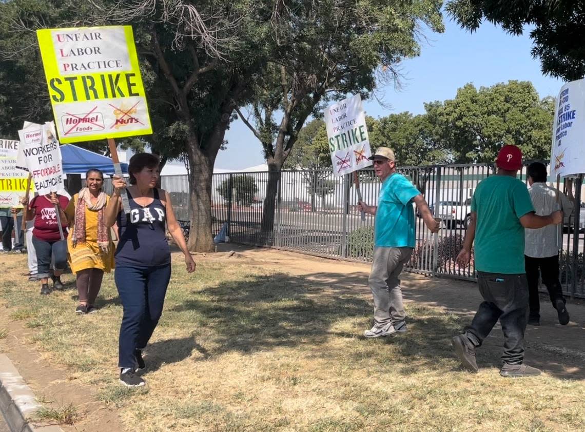 “No contract no crunch.” Around 20 Corn Nut workers march outside of a Fresno production facility as part of a strike on Aug. 18, 2022. They say Corn Nuts owner, Hormel Foods, is not bargaining in good faith.