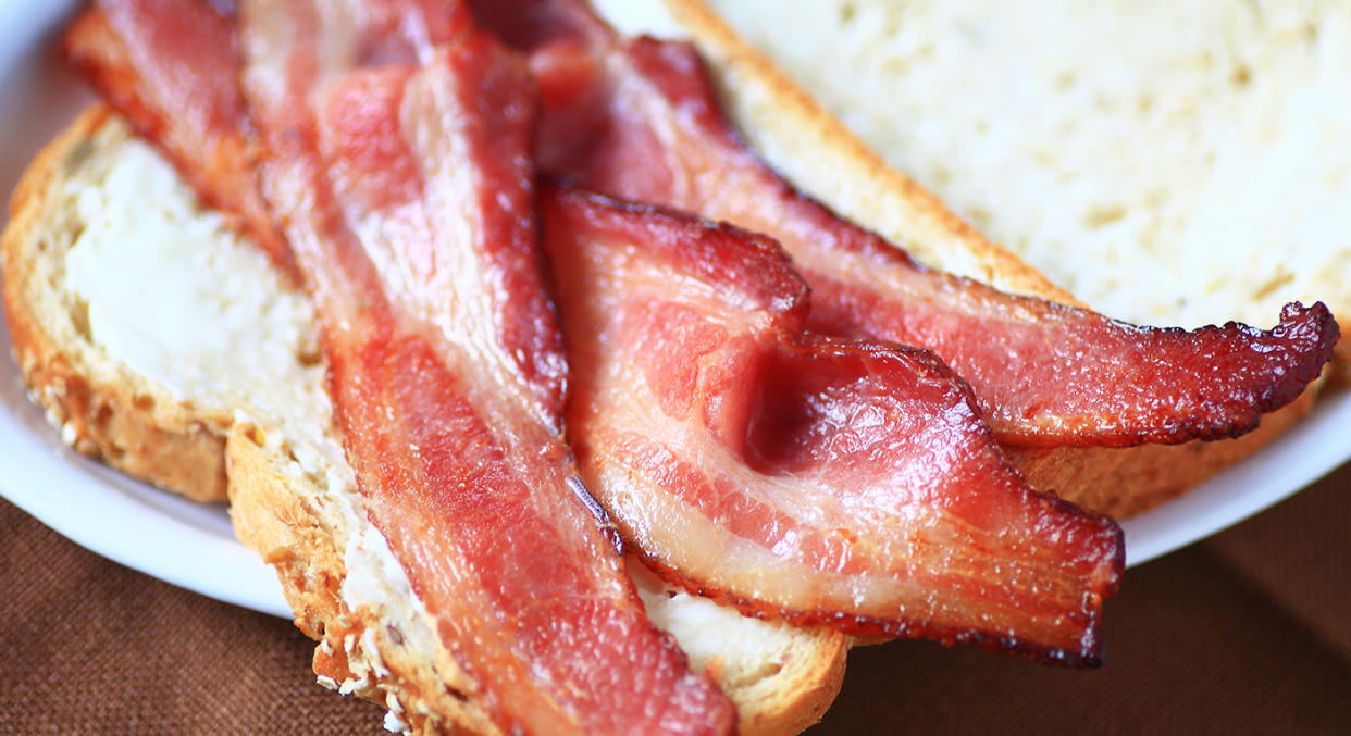 Cut down on processed meats like bacon to lower cancer risk. [Photo: Getty]