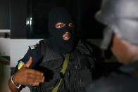 <p>A member of the Malian Security forces discusses operational details during a clearing operation in Kangaba tourist resort in Bamako on June 18, 2017 after suspected jihadists stormed the resort, briefly seizing more than 30 hostages and leaving at least two people dead.<br>(Michele Cattani/AFP/Getty Images) </p>