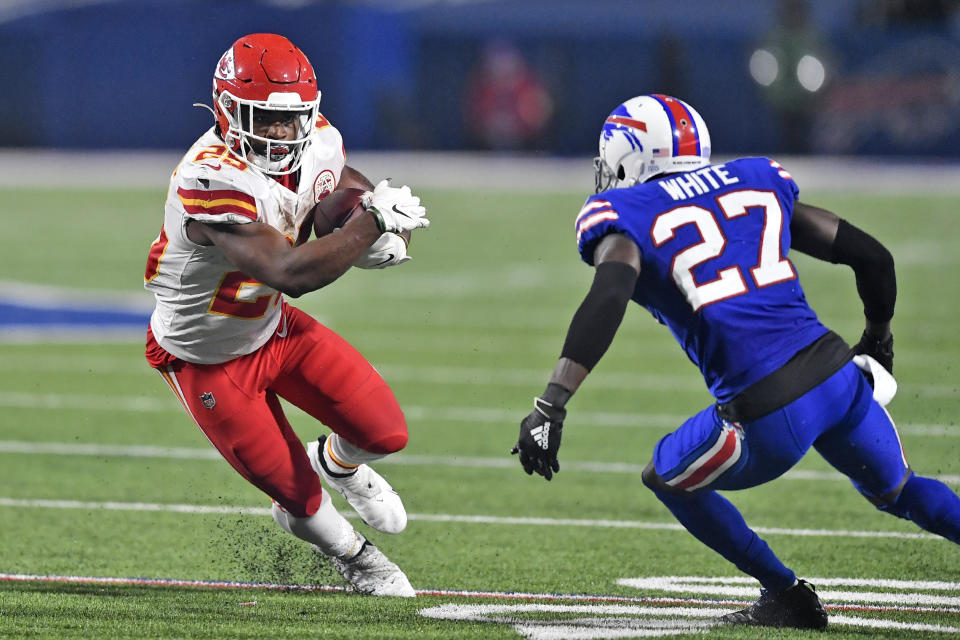 Clyde Edwards-Helaire runs with the ball as Bills cornerback Tre'Davious White defends.