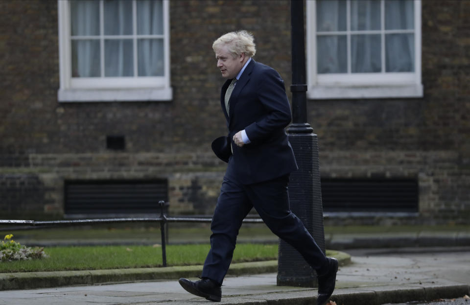 Britain's Prime Minister Boris Johnson returns to 10 Downing Street after meeting with Queen Elizabeth II at Buckingham Palace, London, on Friday, Dec. 13, 2019. Prime Minister Boris Johnson's Conservative Party has won a solid majority of seats in Britain's Parliament — a decisive outcome to a Brexit-dominated election that should allow Johnson to fulfil his plan to take the U.K. out of the European Union next month. (AP Photo/Matt Dunham)