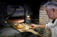 Baking bread over a wood fire in Challans