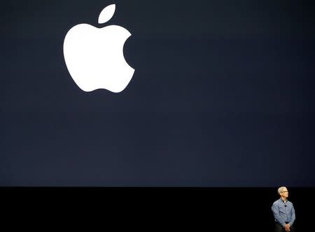 Apple Inc. CEO Tim Cook leads a moment of silence for the victims of the attack in Orlando as he opens the company's World Wide Developers Conference in San Francisco, California June 13, 2016. REUTERS/Stephen Lam/File Photo