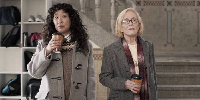 Sandra Oh and Holland Taylor standing next to one another with coffee cups in their hands in The Chair