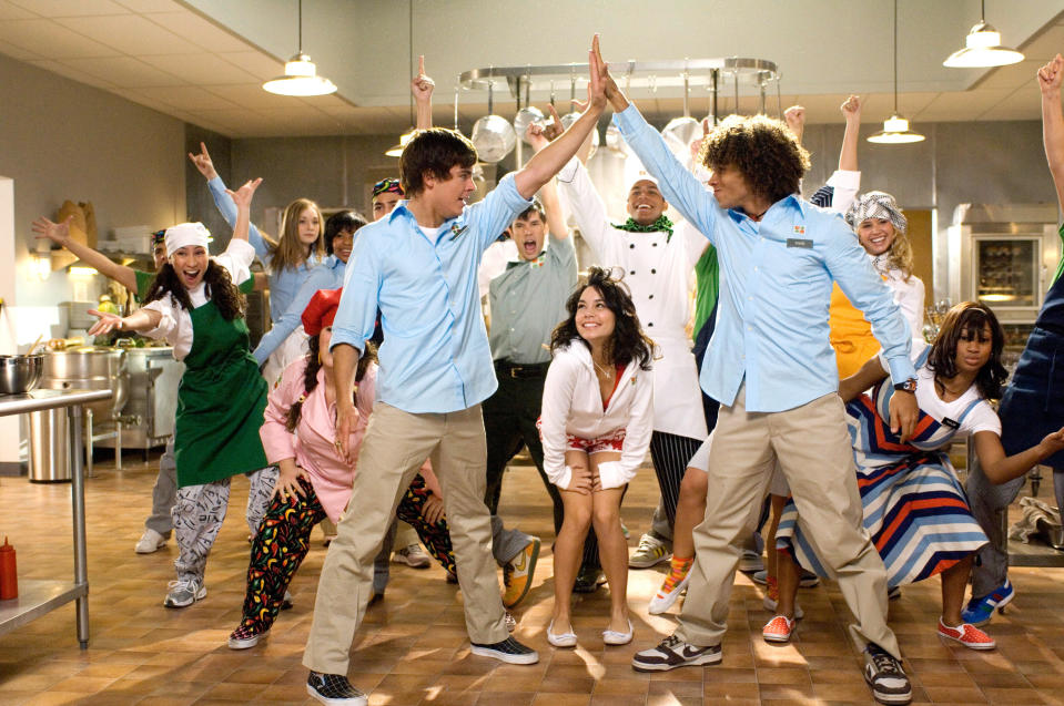 cast of high school musical dancing and singing in a kitchen