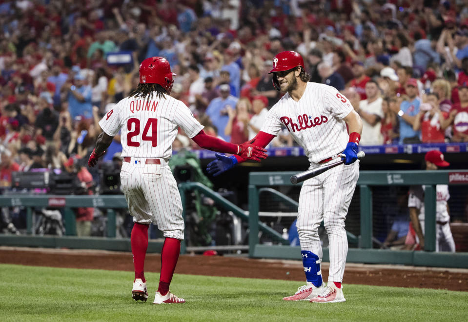 Philadelphia Phillies' Roman Quinn (24) celebrates with Bryce Harper after hitting a home run off of San Diego Padres' Chris Paddack during the third inning of a baseball game Friday, Aug. 16, 2019, in Philadelphia. (AP Photo/Matt Rourke)