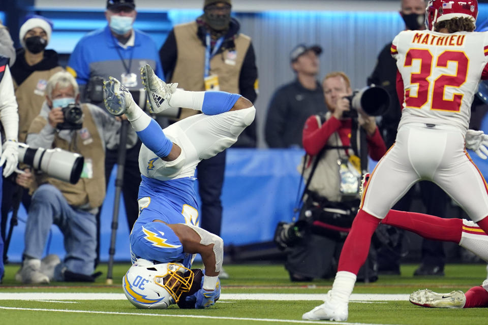 Los Angeles Chargers running back Austin Ekeler, left, hauls in a pass during the second half of an NFL football game against the Kansas City Chiefs, Thursday, Dec. 16, 2021, in Inglewood, Calif. (AP Photo/Marcio Jose Sanchez)