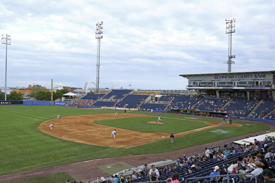 FILE - This Sunday, June 28, 2015, file photo shows an overall view of the Staten Island Yankees in action against the State College Spikes at Richmond County Bank Ballpark during a minor league baseball game in Staten Island, N.Y. The owners of the Staten Island Yankees announced in a statement Thursday, Dec. 3, 2020, that with “great regret, we must cease operations.” They also said they were suing the New York Yankees and Major League Baseball “to hold those entities accountable for false promises” that they would always keep the team as a farm club. (AP Photo/Gregory Payan, File)
