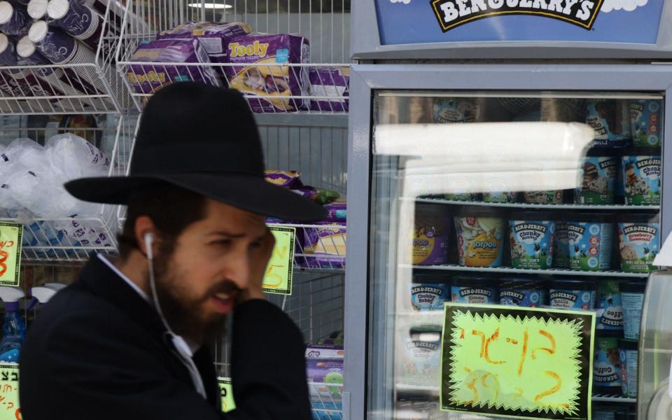 An Ultra Orthodox Jewish man walks by Ben &amp; Jerry&#39;s ice cream in Jerusalem&#xa0; - AHMAD GHARABLI/AFP via Getty Images