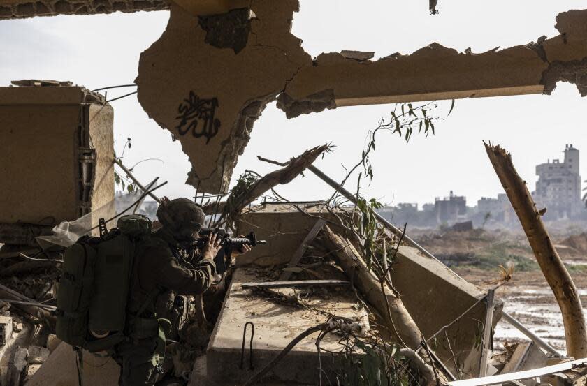 --PHOTO TAKEN DURING A CONTROLLED TOUR AND SUBSEQUENTLY EDITED UNDER THE SUPERVISION OF THE ISRAELI MILITARY-- This picture taken during a media tour organised by the Israeli military on January 8, 2024, shows a soldier securing a position in al-Bureij in the central Gaza Strip, amid continuing battles between Israel and the Palestinian militant group Hamas. (Photo by Menahem KAHANA / AFP) (Photo by MENAHEM KAHANA/AFP via Getty Images)