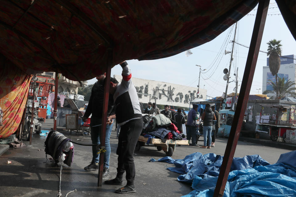 Followers of Shiite cleric Muqtada al-Sadr dismantle their tents in preparation for withdrawing from the anti-government protests in Tahrir Square in Baghdad, Iraq, Saturday, Jan. 25, 2020. Iraq's anti-government protests were dealt a blow after a powerful cleric Shiite withdrew his support from the movement. Shortly after they packed up and left, security forces to set fire to protesters' tents overnight Saturday in the country's south, as well as re-open key public squares in Baghdad that had been occupied by the demonstrators. (AP Photo/Hadi Mizban)