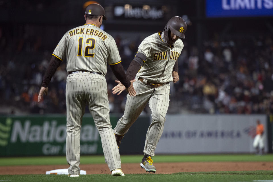 San Diego Padres' Trent Grisham, right, gets a congratulatory handshake from third base coach Bobby Dickerson (12) after hitting a two-run home run against the San Francisco Giants during the sixth inning of a baseball game, Friday, May 7, 2021, in San Francisco. (AP Photo/D. Ross Cameron)