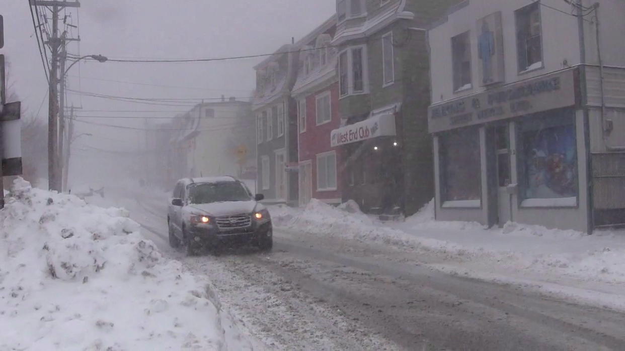 A car drives downs a snow-covered street in St. John’s on Wednesday, Jan. 2, 2019. THE CANADIAN PRESS/Holly McKenzie-Sutter