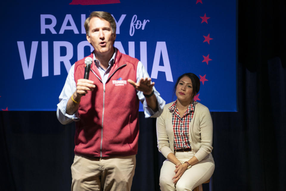 Youngkin speaks at a rally for Virginia Republican congressional candidate Yesli Vega, who sits behind him.