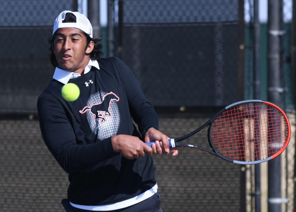 Coronado's Daniel Warraich hits the ball in the boys doubles final of the District 4-5A tennis tournament.