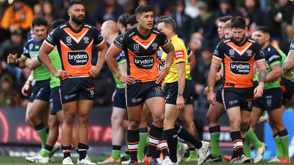 Wests Tigers players look on during a break in play in an NRL game against the Canberra Raiders.