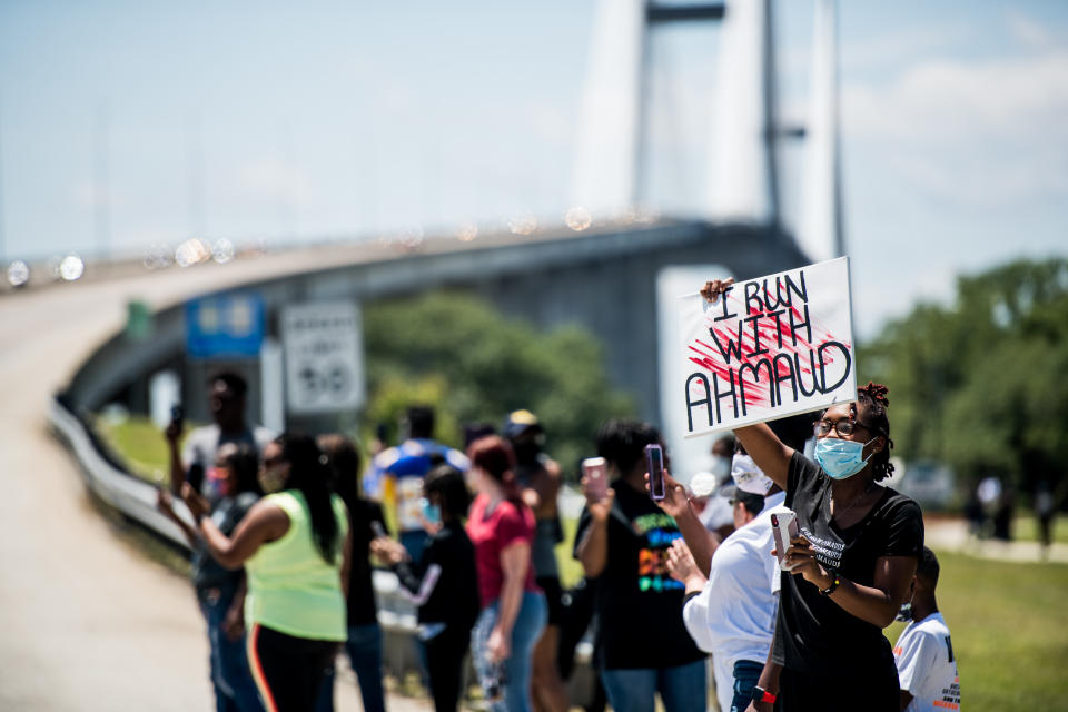 Demonstrators watch a parade of passing motorcyclists riding in honor of Ahmaud Arbery in Brunswick, Ga. (Sean Rayford/Getty Images)