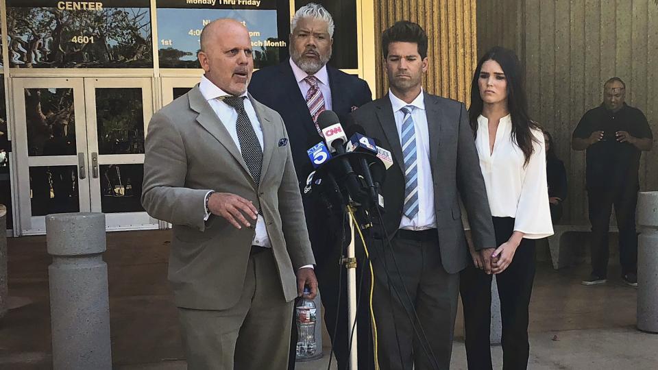 Reality show doctor Grant Robicheaux, second from right, and his girlfriend Cerissa Riley, right, listen as Robicheaux's attorney speaks.&nbsp; (Photo: Yahoo Magazines PYC)