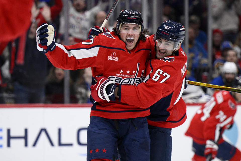 Washington Capitals right wing T.J. Oshie (77) celebrates his goal against the St. Louis Blues with left wing Max Pacioretty (67) during the first period of an NHL hockey game Thursday, Jan. 18, 2024, in Washington. (AP Photo/Nick Wass)
