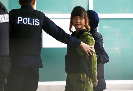 Vietnamese Doan Thi Huong who is on trial for the killing of Kim Jong Nam, the estranged half-brother of North Korea's leader, is escorted as she arrives at the Department of Chemistry in Petaling Jaya, near Kuala Lumpur, Malaysia. REUTERS/Lai Seng Sin