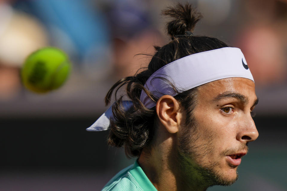 Italy's Lorenzo Musetti plays a shot against Britain's Cameron Norrie during their third round match of the French Open tennis tournament at the Roland Garros stadium in Paris, Friday, June 2, 2023. (AP Photo/Thibault Camus)