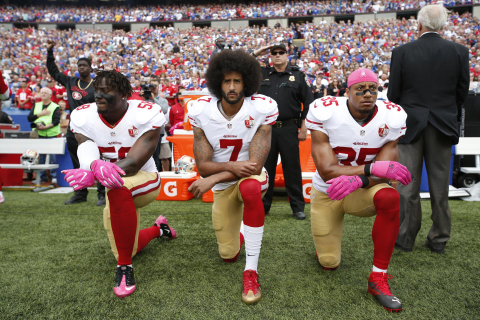 Eli Harold #58, Colin Kaepernick #7 and Eric Reid #35 of the San Francisco 49ers kneel in protest on the sideline, during the anthem, prior to the game against the Buffalo Bills at New Era Field on October 16, 2016 in Orchard Park, New York. The Bills defeated the 49ers 45-16. (Photo by Michael Zagaris/San Francisco 49ers/Getty Images)