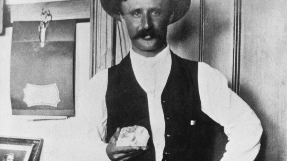 A miner holds the Cullinan Diamond shortly after it was found. After cutting, it was used for the British Crown and Sceptre. (Photo by © Hulton-Deutsch Collection/CORBIS/Corbis via Getty Images)