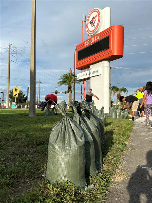 Around two dozen residents fill sandbags for their homes at the Sarasota County government-run sandbag station around 6 p.m. Monday, Aug. 28, 2023 in preparation for Hurricane Idalia, which was expected to brush Manatee and Sarasota counties.