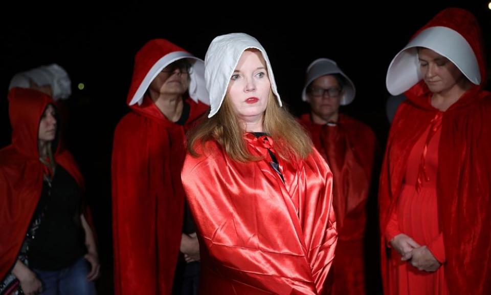 Protesters dressed as handmaids at a Roy Moore rally