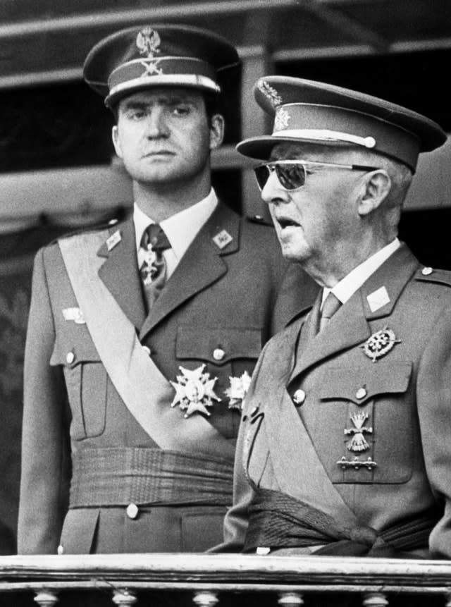 Then dictator General Franco of Spain with the then prince Juan Carlos de Bourbon, at a military parade in Madrid (Archive/PA)