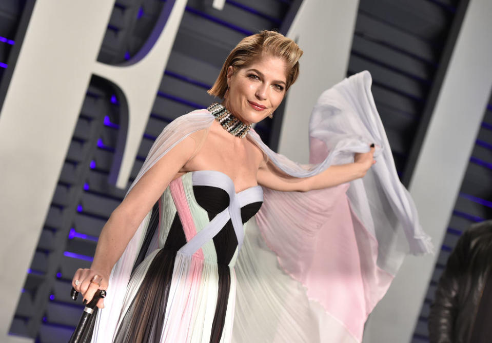 Selma Blair in a multicolored gown on the red carpet for the vanity fair oscar party