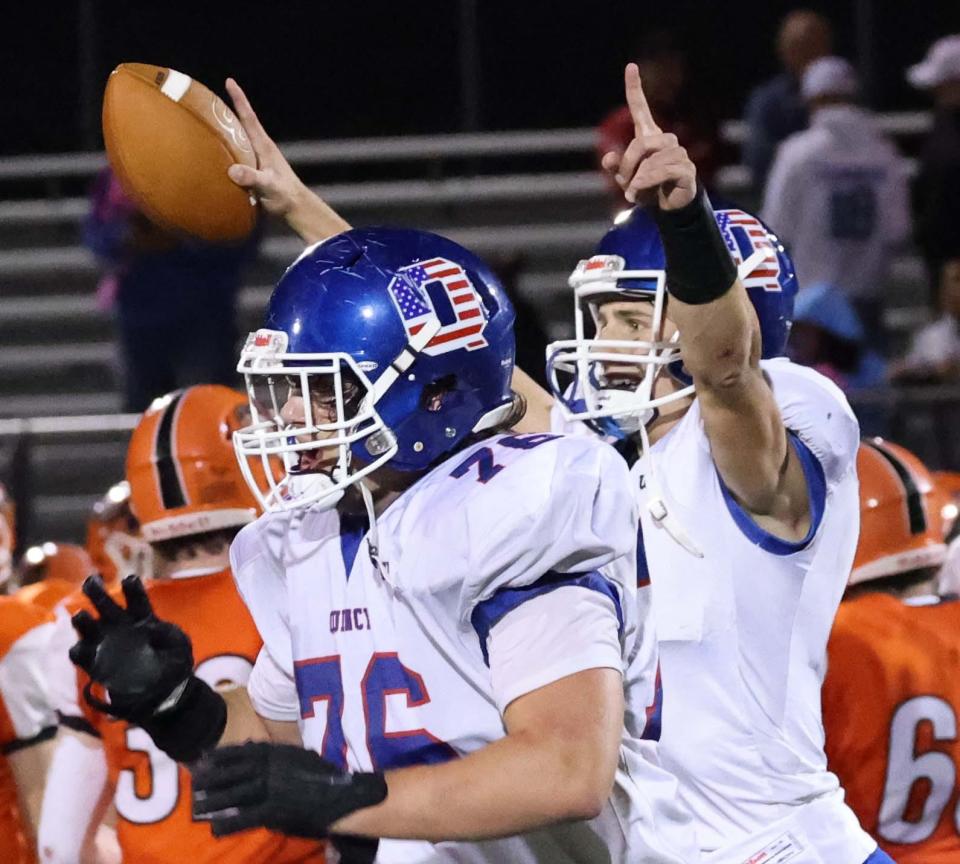 From left, Quincy's Luke Murphy, and Andrew Novak celebrate at the conclusion of their game versus Oliver Ames on Friday, Sept. 16, 2022.