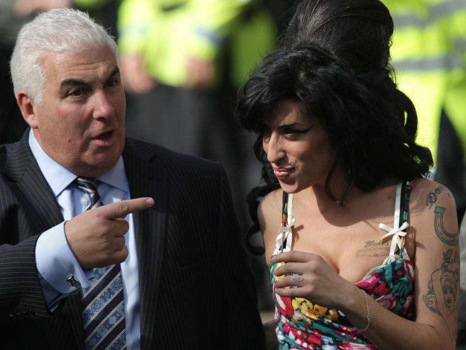 Amy Winehouse arrives with her father Mitch (left) at City of Westminster Magistrates Court in London for her court appearance.